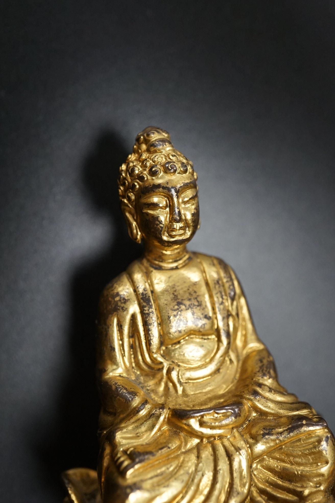 A Chinese miniature gilt metal figure of seated Buddha, 8cm high